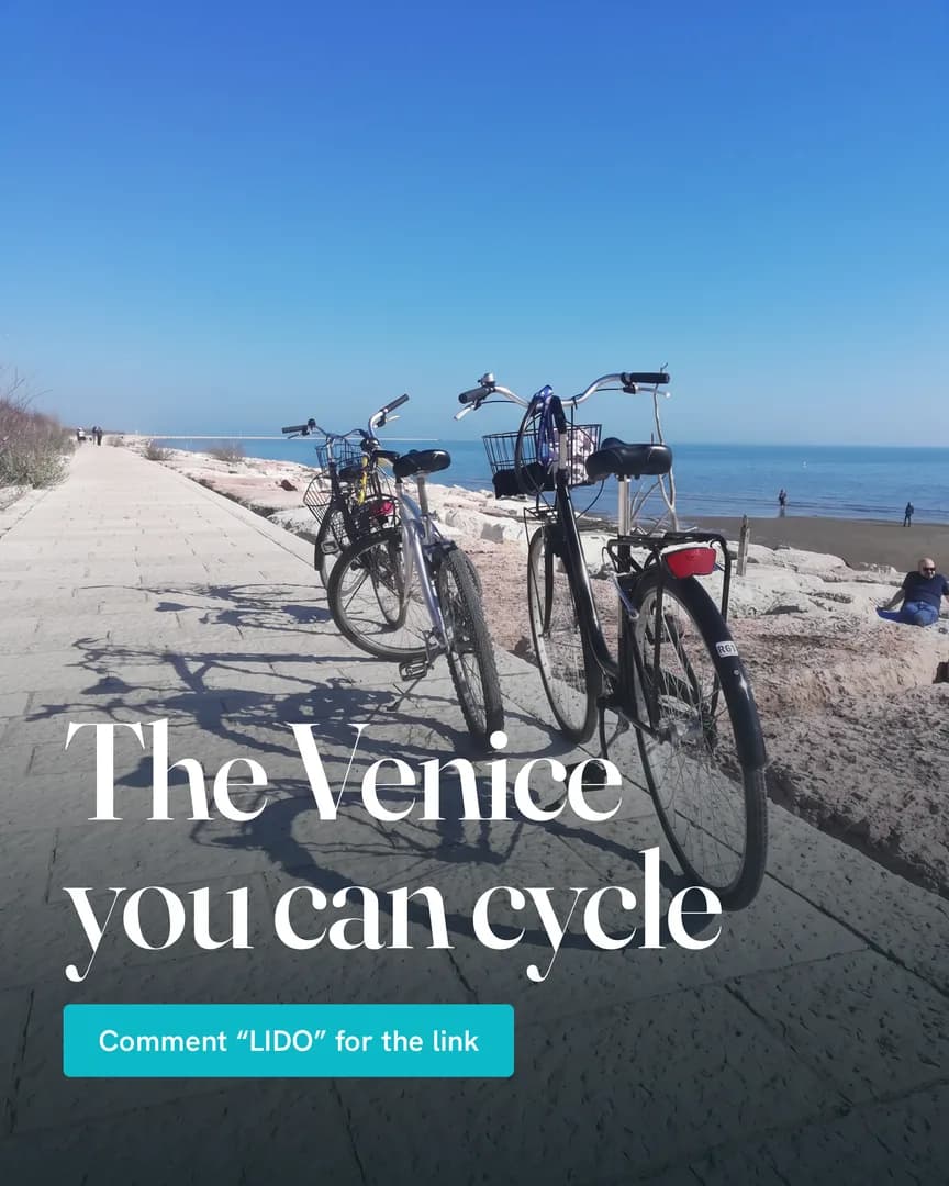 Two bikes parked on the Lido's stone seafront promenade, with the beach and the Adriatic behind.