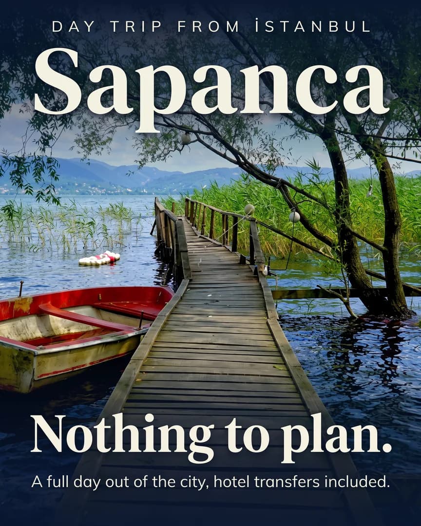 A wooden jetty and a red rowboat on Sapanca Lake, framed by trees and reeds.