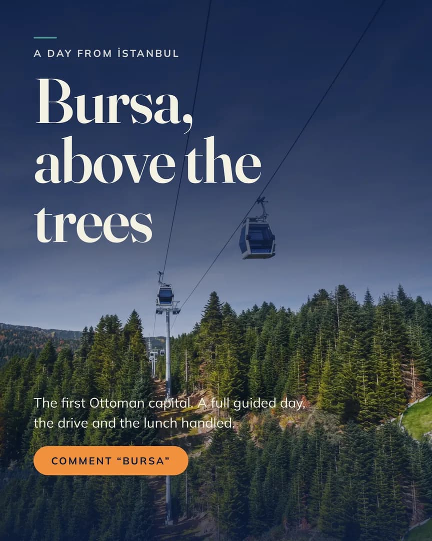 Two cable car gondolas rising over the green pine forest on the mountain above Bursa.