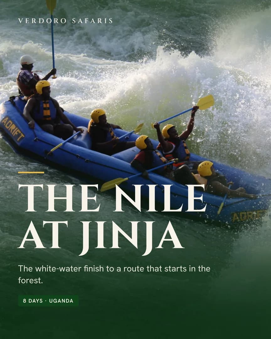 A blue raft of paddlers in yellow helmets punching through a white-water wave on the Nile.